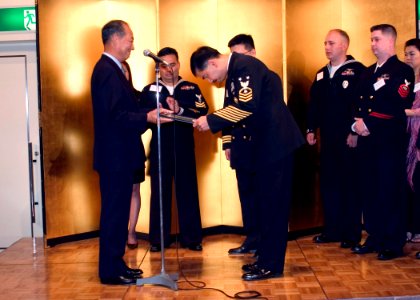 US Navy 061122-N-2716P-009 U.S. Navy Friendship Association (JANAFA) President and Retired Japan Maritime Self-Defense Force (JMSDF) Vice Adm. Makoto Yamamoto, presents Command Master Chief Marcos F. Sibal, assigned to Fleet A