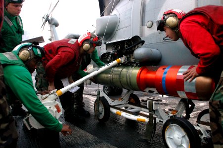 US Navy 061117-N-3136P-119 Sailors assigned to Helicopter Anti-Submarine Light Squadron Five One (HSL-51), load an Mk-46 anti-submarine torpedo onto a SH-60B Seahawk helicopter on the flight deck of USS Kitty Hawk (CV 63)