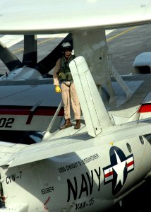 US Navy 061122-N-8907D-003 A pilot assigned to the Tigertails of Carrier Airborne Early Warning Squadron One Two Five (VAW-125) inspects an E-2C Hawkeye before flight operations