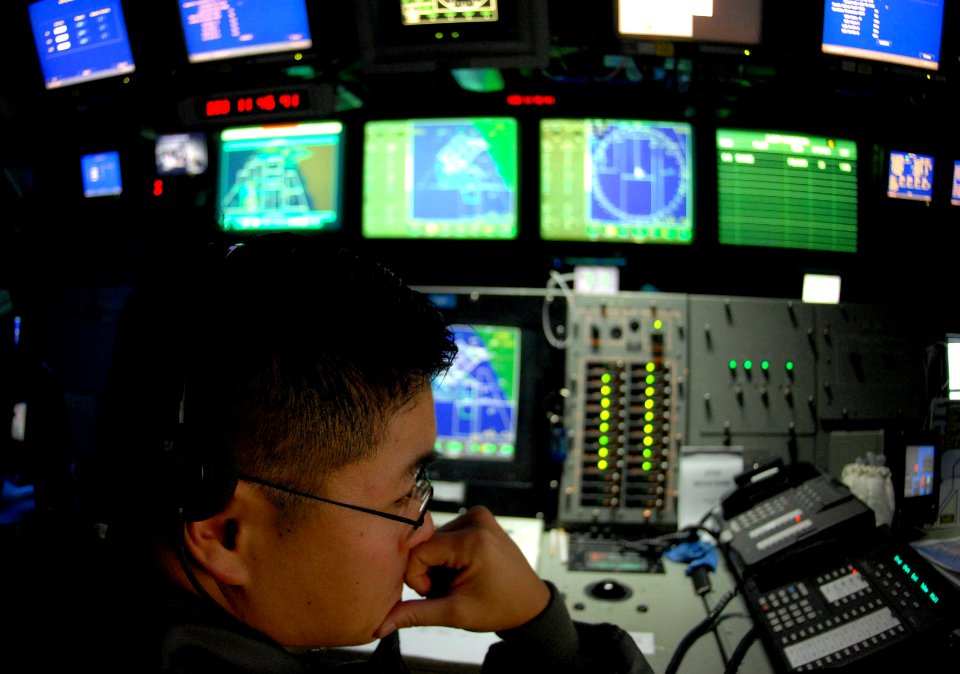 US Navy 061116-N-4776G-201 Lt. Marvin Park mans the tactical action officer watch in the Combat Direction Center aboard USS Ronald Reagan (CVN 76)