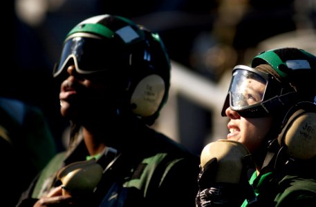 US Navy 061116-N-7130B-158 From the catwalks surrounding the flight deck of USS Ronald Reagan (CVN 76), Airman Stephanie Lasiano responds to her supervisor's question about the waist catapults
