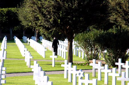 US Navy 061117-N-6544L-004 A Soldier assigned to the American Embassy in Tunis touches a headstone at the North African American Cemetery during a wreath-laying ceremony honoring American veterans