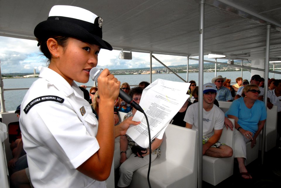US Navy 061115-N-4965F-006 Airman Apprentice Victoria Sheppard, narrator and bow hook for the USS Arizona Memorial Detachment white boat crew, explains the history of the U.S. Navy at Pearl Harbor for members of the Profession