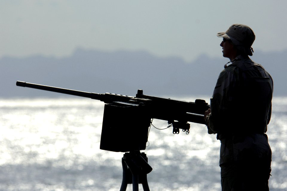 US Navy 061119-N-8148A-001 U.S. Navy Master at Arms Seaman Recruit Jessee Seaman, assigned to Mobile Security Squadron Three (MSS-3), stands the .50 caliber machine gun watch