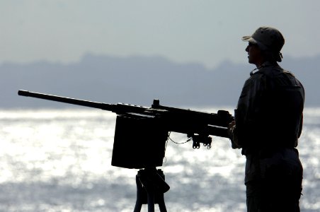 US Navy 061119-N-8148A-001 U.S. Navy Master at Arms Seaman Recruit Jessee Seaman, assigned to Mobile Security Squadron Three (MSS-3), stands the .50 caliber machine gun watch