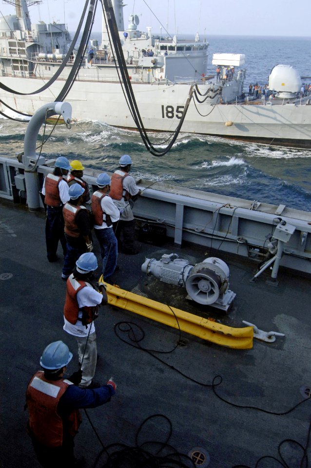 US Navy 061117-N-8148A-113 U.S. Navy line handlers aboard the Military Sealift Command (MSC) fast combat support ship USNS Supply (T-AOE 6) stabilize a communication line during an underway replenishment