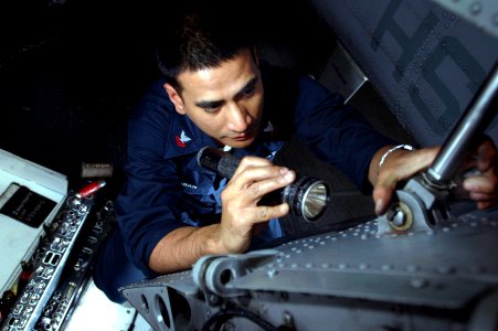 US Navy 061127-N-1332Y-140 Aviation Structural Mechanic 2nd Class Stewart Laparan, from Manila, Philippines, inspects the center snap area on the tail section of a SH-60B Seahawk assigned to Helicopter Anti-Submarine Squadron L