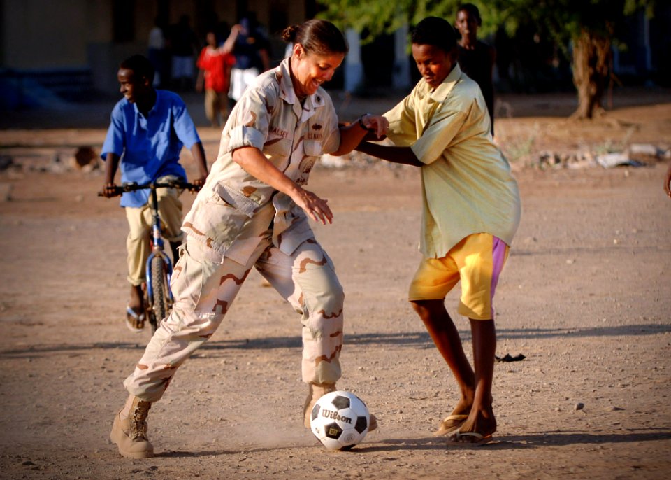 US Navy 061120-N-1328C-213 Lt. Cmdr. Wendy Halsey from Honolulu, Hawaii, plays in a soccer game at the Djibouti Boy's Orphanage in Djibouti City, Djibouti. Halsey's friends and family collected more than 300 soccer balls
