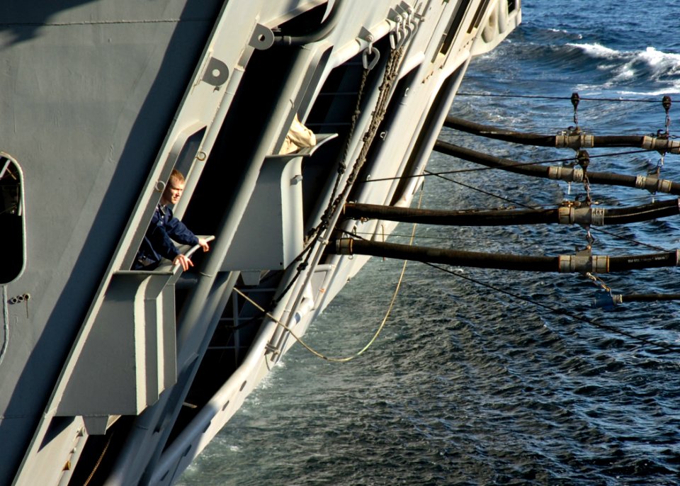 US Navy 061127-N-8907D-001 A Sailor watches as the Nimitz-class aircraft carrier USS Dwight D. Eisenhower (CVN 69) takes on fuel and other supplies from the Military Sealift Command (MSC) underway replenishment oilier USNS Lara