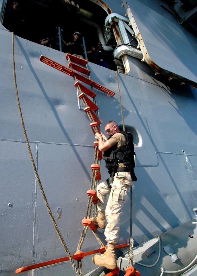 US Navy 061121-N-8547M-020 Chief Aviation Structural Mechanic Christopher Carlson practices boarding amphibious assault ship USS Saipan (LHA 2) via a Jacobs ladder during Visit, Board, Search and Seizure (VBSS) tr