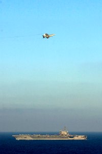 US Navy 061115-N-7130B-187 In the skies above USS Ronald Reagan (CVN 76), an F-A-18E Super Hornet circles the approach pattern to make an arrested landing aboard the ship