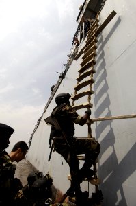 US Navy 061121-F-0560B-214 Cameroonian Navy Sailors climb aboard the French Frégates de surveillance FS Germinal F735 while performing a visit, board, search and seizure drill (VBSS) in Douala, Cameroon, part of exercise RECAMP