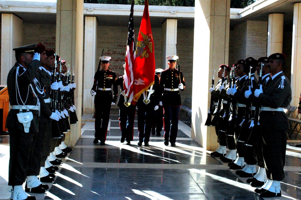 US Navy 061117-N-6544L-005 The Marine Corps color guard assigned to the American Embassy in Tunis marches past a corridor of Tunisian honor guards while retiring the colors during a wreath-laying ceremony at the North African A
