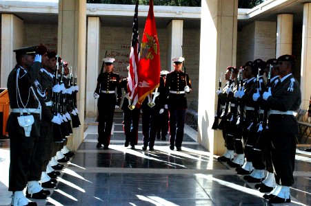 US Navy 061117-N-6544L-005 The Marine Corps color guard assigned to the American Embassy in Tunis marches past a corridor of Tunisian honor guards while retiring the colors during a wreath-laying ceremony at the North African A
