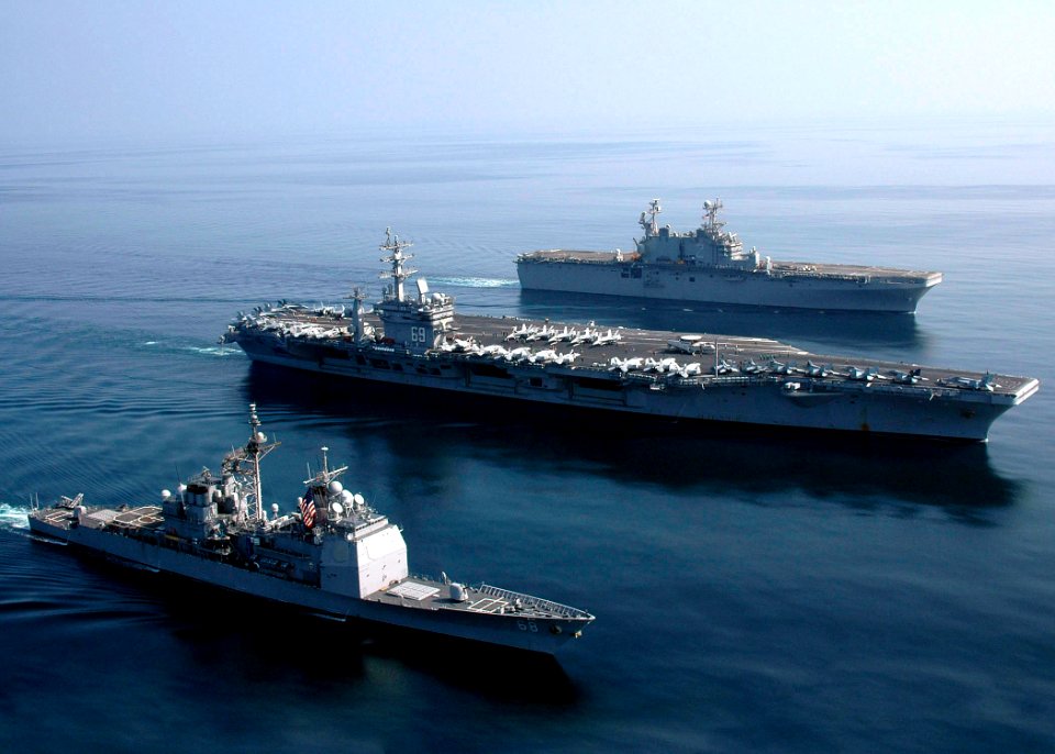 US Navy 061120-N-8547M-140 The guided-missile cruiser USS Anzio (CG 68), the Nimitz-class aircraft carrier USS Dwight D. Eisenhower (CVN 69), and amphibious assault ship USS Saipan (LHA 2) sail in formation during a photographi