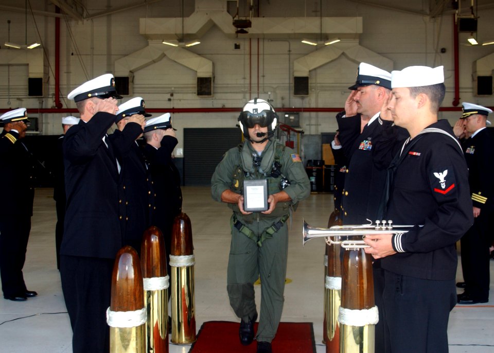 US Navy 061130-N-1810F-022 Aviation Warfare System Operator 1st Class Guy Toughton, assigned to Helicopter Anti-Submarine Squadron Light Four Six (HSL-46), passes through side boys as he carries the remains of Chief Aviation St
