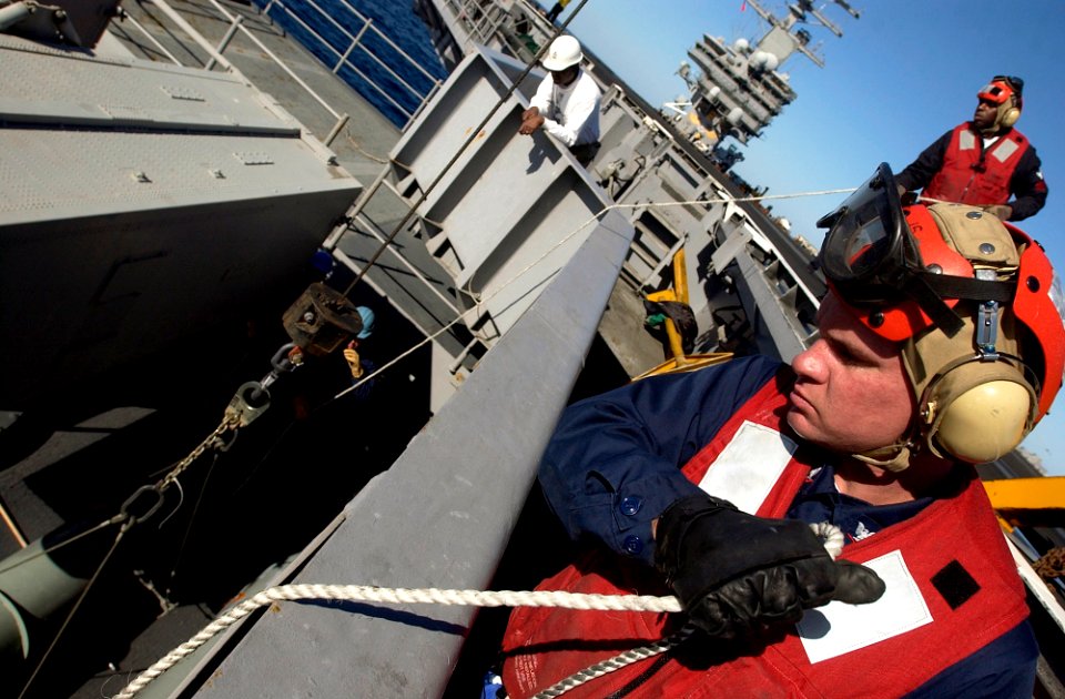 US Navy 061130-N-7130B-156 High in the catwalk above USS Ronald Reagan (CVN 76) forward NATO Sea Sparrow launcher, members of the combat system department's CS-7 division hold steady lines to balance the load of an AIM-7