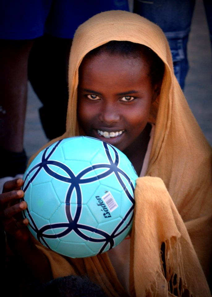 US Navy 061119-N-1328C-202 A young student from Balbala School holds a soccer ball given to her by service members from Combined Joint Task Force - Horn of Africa