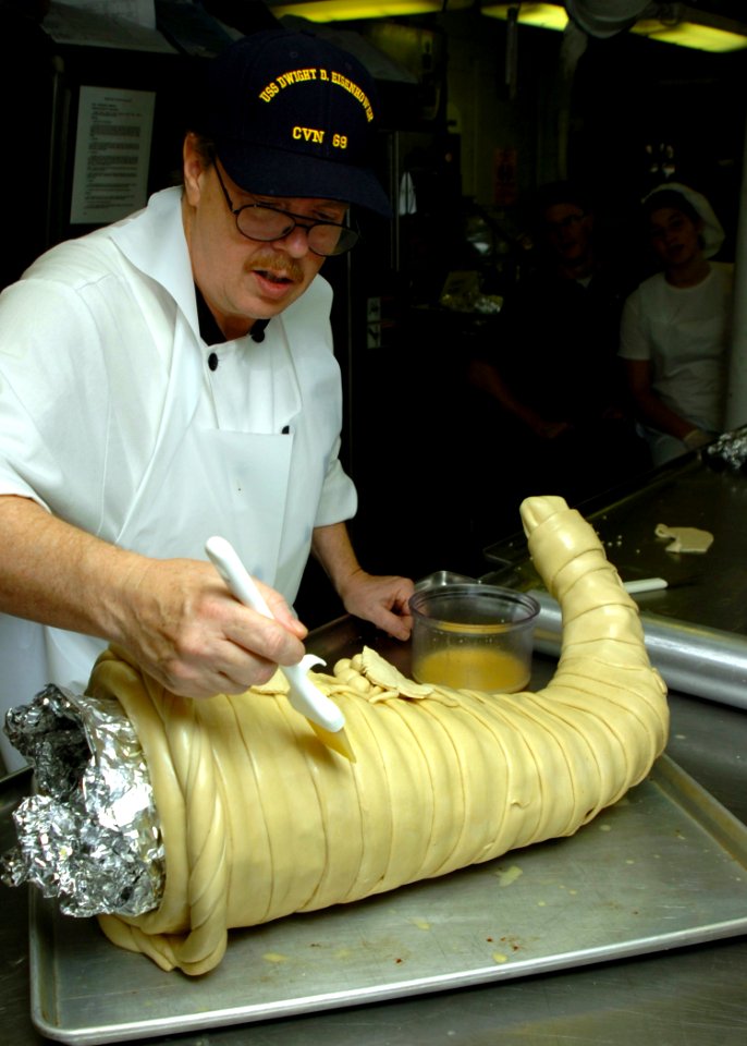 US Navy 061123-N-8907D-001 Chef instructor Denzel McCoy prepares a Thanksgiving dish for the crew of Nimitz-class aircraft carrier USS Dwight D. Eisenhower (CVN 69)