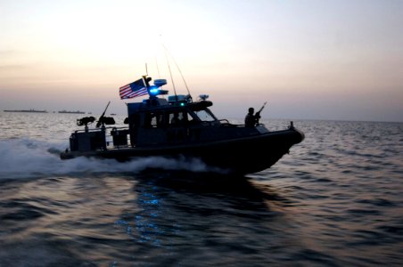 US Navy 061124-N-3642E-006 A rigid hull inflatable boat (RHIB) provides an escort for the Secretary of the Navy (SECNAV) The Honorable Dr. Donald C. Winter