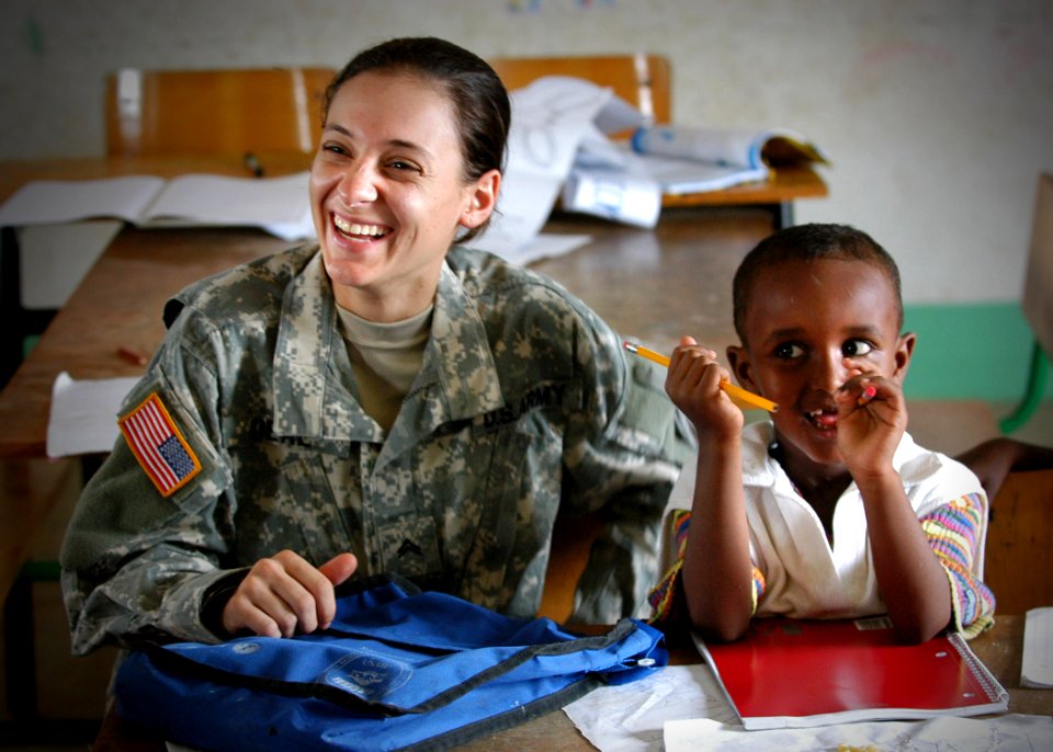 US Navy 061202-N-1328C-071 U.S. Army Spc. Danielle Deal, attached to Bravo Co., 489th, Civil Action Battalion, visits with students at the Djibouti City school