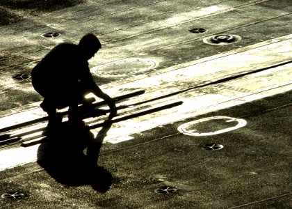 US Navy 061126-N-8907D-001 A Sailor works on a catapult before flight operations aboard the Nimitz-class aircraft carrier USS Dwight D. Eisenhower (CVN 69)