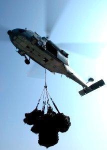 US Navy 061118-N-8547M-093 An MH-60S Knighthawk Helicopter lifts off the flight deck of amphibious assault ship USS Saipan (LHA 2) during a vertical replenishment (VERTREP) with Military Sealift Command fast-combat logistic su