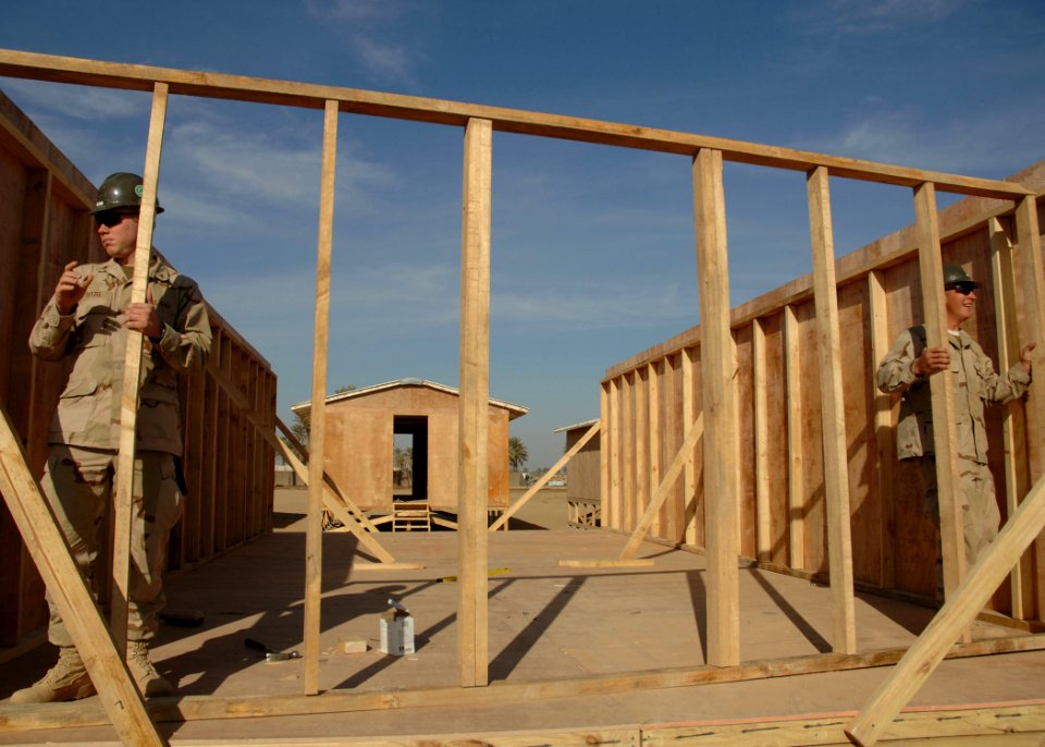 US Navy 061125-N-6889J-026 Religious Program Specialist 3rd Class Joseph Ditzel and Builder 3rd Class Mathew Speece of Naval Mobile Construction Battalion Seven Four (NMCB-74) set a wall at Camp Ramadi