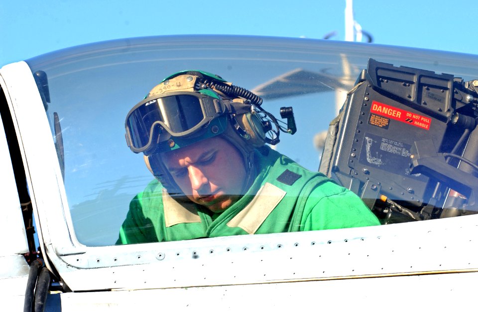 US Navy 061202-N-5484G-056 Aviation Electronics Technician 2nd Class David Walters loads new computer software for an F-A-18F Super Hornet on the flight deck aboard the nuclear-powered aircraft carrier USS Nimitz (CVN 68)
