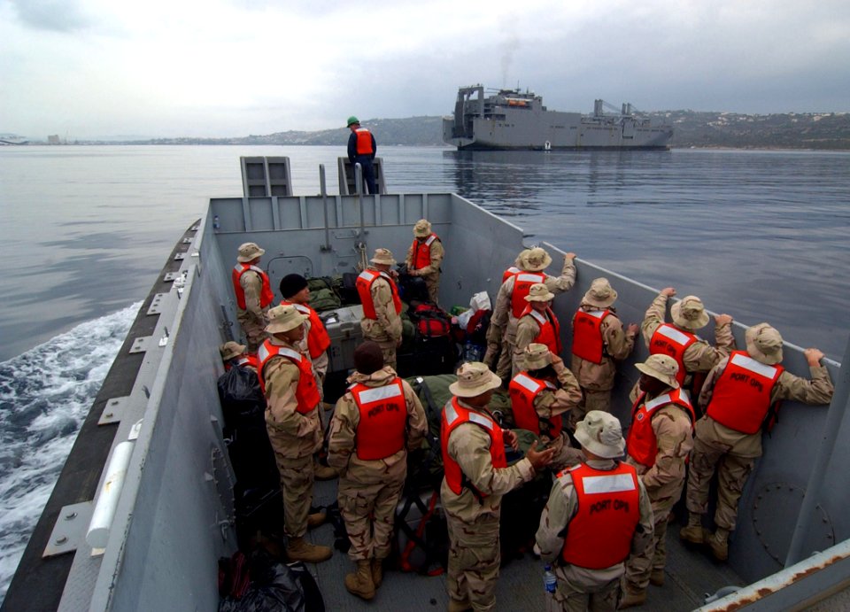 US Navy 061203-N-0780F-011 Sailors of Mobile Security Detachment 32 is transported in a U.S. Navy 50-foot workboat to embark on board Military Sealift Command (MSC) roll-on-roll-off ship USNS Soderman (T-AKR 317) at anchor in