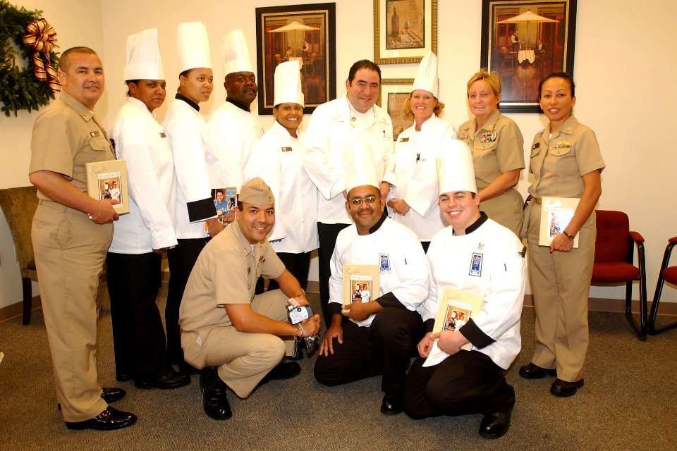 US Navy 061129-N-8544C-029 Renowned culinary-genius and national television personality, Emeril Lagasse poses with Culinary Specialists on board Naval Air Station (NAS) Jacksonville, Fla