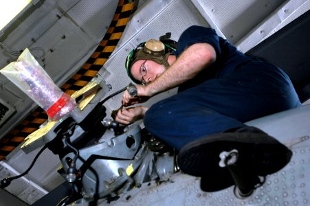 US Navy 061127-N-1332Y-041 Aviation Electrician's Mate Airman David Hartmon, from Somerset, Wis., removes a part from the tail section of an SH-60B Seahawk assigned to Helicopter Anti-Submarine Squadron Light Five One (HSL-51)