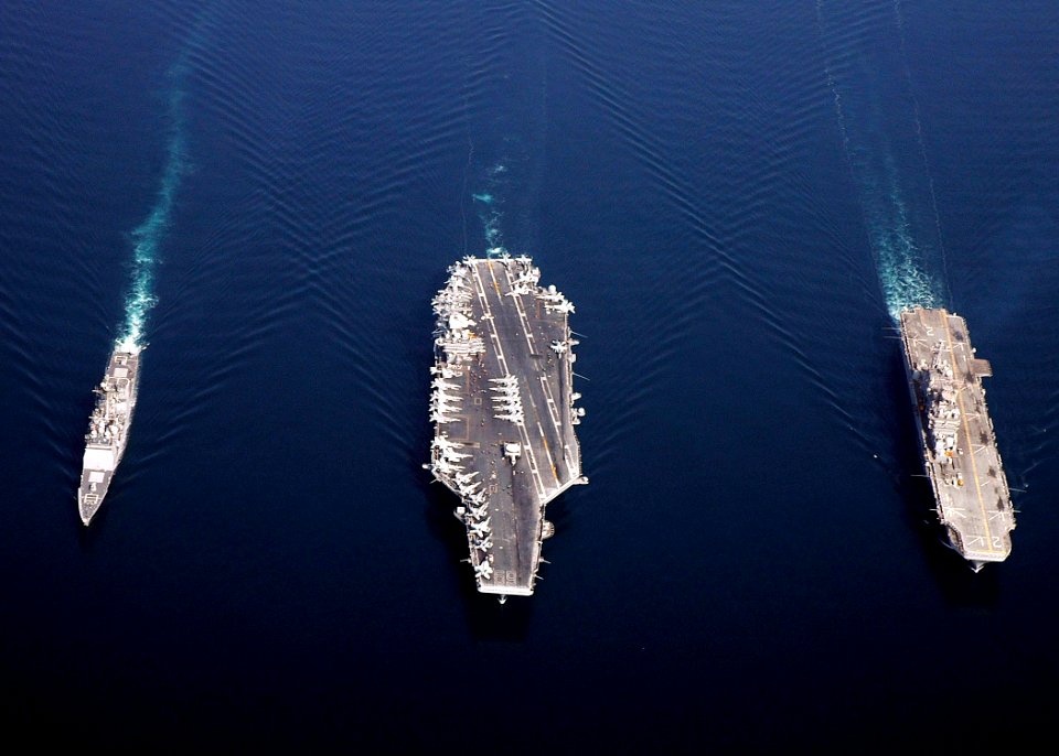 US Navy 061120-N-8547M-408 The guided-missile cruiser USS Anzio (CG 68), the Nimitz-class aircraft carrier USS Dwight D. Eisenhower (CVN 69), and amphibious assault ship USS Saipan (LHA 2) sail in formation during a photographi