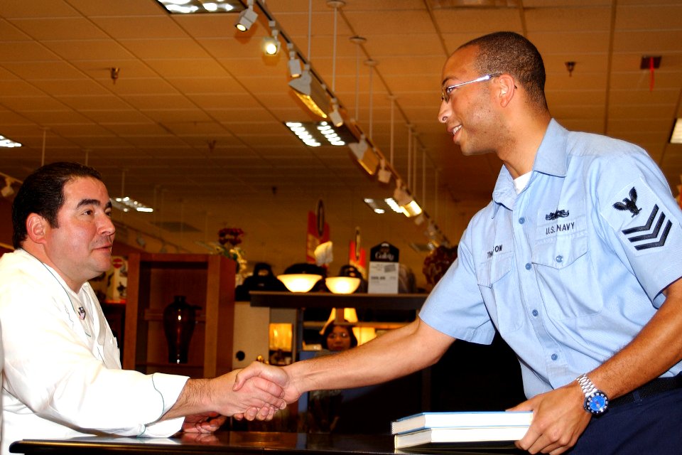 US Navy 061129-N-8544C-073 Torpedoman's Mate 1st Class Jarrod Thompson assigned to the Weapons department on board Naval Air Station (NAS) Jacksonville, Fla., shakes hands with renowned culinary-genius and national television p