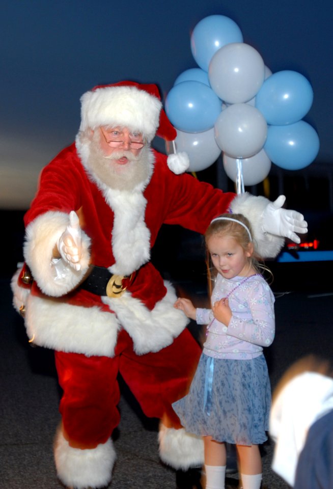 US Navy 061127-N-5459S-009 Santa Claus welcomes children of military service members during Operation Christmas at the Army National Guard Armory