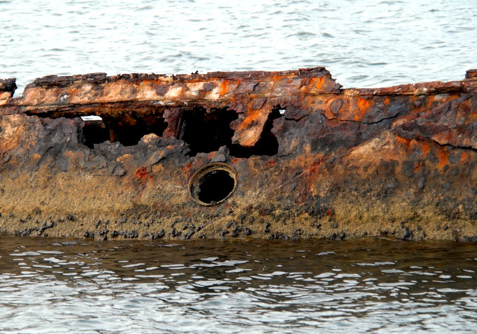 US Navy 061203-N-4774B-014 The rusted hull of the USS Utah remains in the water just off Ford Island. Three aerial torpedoes struck the Utah, causing the ship to sink during the 1941 attack