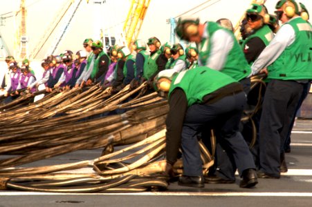 US Navy 061129-N-0455L-011 ailors assigned to the air department aboard the Nimitz-class aircraft carrier USS Harry S. Truman (CVN 75) raise the aircraft barricade during flight deck training drills