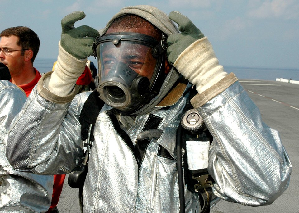 US Navy 061201-N-8547M-013 Aviation Boatswain's Mate 3rd Class Nnamdi U. Emenogu assigned to crash and salvage dresses out in flight deck fire fighting gear in preparation to fight a fire on the flight deck of amphibious