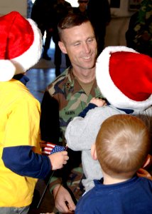 US Navy 061205-N-XXXXW-003 Naval Mobile Construction Battalion One (NMCB-1), Executive Officer, Lt. Cmdr. Eric J. Hawn, greets his three children after returning from the battalion's six-month deployment to the Far East