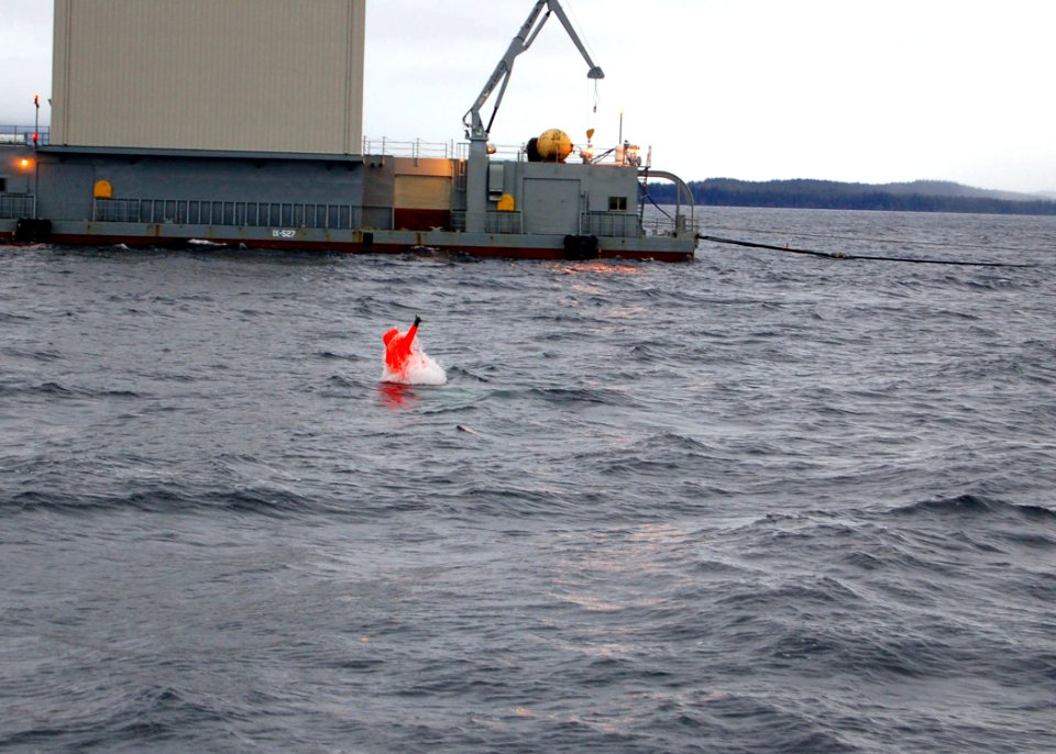 US Navy 061202-N-9486C-005 Fire Control Technician 2nd Class Gary Halsey emerges from the Northern Pacific as the first Navy Sailor to execute a tandem open ocean escape from a nuclear-powered submarine