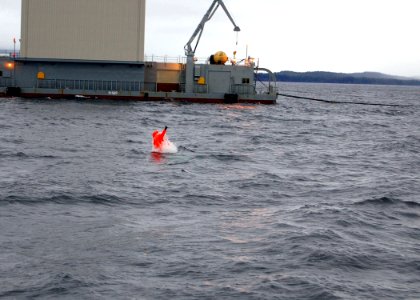 US Navy 061202-N-9486C-005 Fire Control Technician 2nd Class Gary Halsey emerges from the Northern Pacific as the first Navy Sailor to execute a tandem open ocean escape from a nuclear-powered submarine