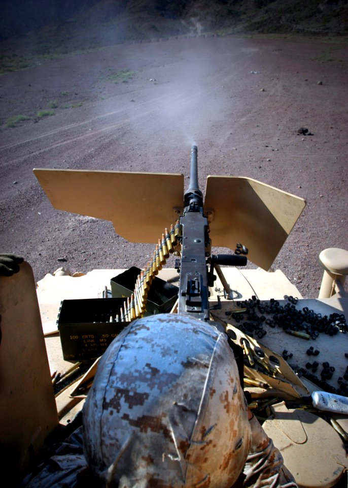US Navy 061203-N-1328C-134 A U.S. Marine fires 50 cal. rounds down range, during a 5th Provisional Security Company 50 cal. qualification shot