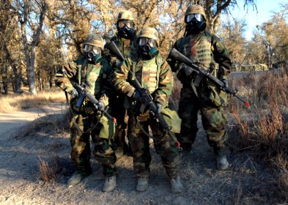 US Navy 061202-N-3560G-021 Members of Naval Mobile Construction Battalion Four (NMCB-4) demonstrate the proper donning of the Chemical Protective Overgarment during field exercise Operation Bearing Duel