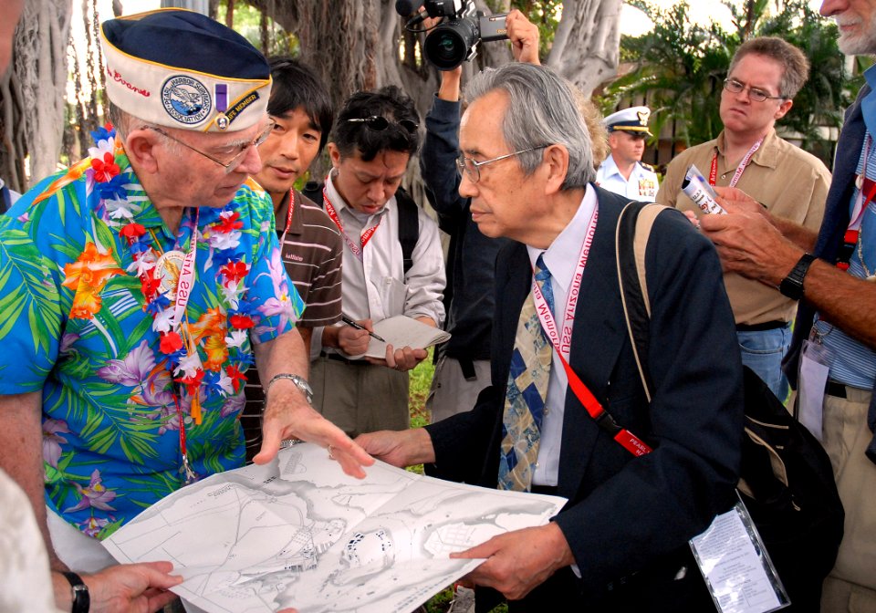 US Navy 061203-N-4774B-002 Pearl Harbor Survivor, retired Capt. Jack Evans shows Akinori Suzuki, of the Japanese news agency Asahi Broadcasting, where he stood during the initial bombings of the attack on Pearl Harbor