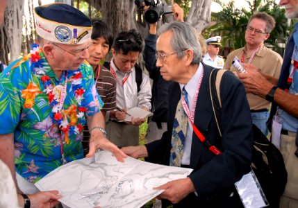 US Navy 061203-N-4774B-002 Pearl Harbor Survivor, retired Capt. Jack Evans shows Akinori Suzuki, of the Japanese news agency Asahi Broadcasting, where he stood during the initial bombings of the attack on Pearl Harbor