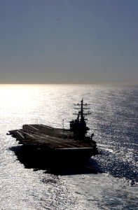 US Navy 061202-N-7130B-068 As the sun begins to set over the Pacific Ocean, USS Ronald Reagan (CVN 76) prepares to conduct maneuvering drills