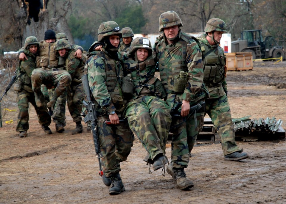 US Navy 061203-N-3560G-014 Members of Naval Mobile Construction Battalion Four (NMCB-4) transport wounded to the Battle Aid Station (BAS) during a mass casualty drill at the field exercise Operation Bearing Duel