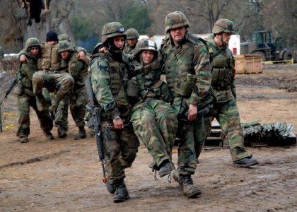 US Navy 061203-N-3560G-014 Members of Naval Mobile Construction Battalion Four (NMCB-4) transport wounded to the Battle Aid Station (BAS) during a mass casualty drill at the field exercise Operation Bearing Duel