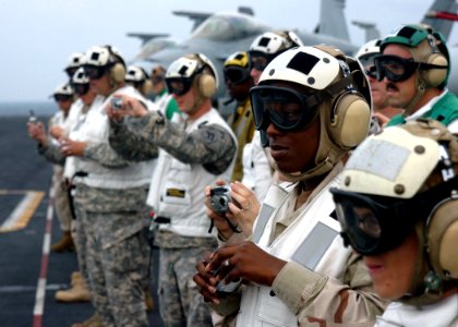 US Navy 061204-N-8907D-006 Senior enlisted advisors assigned to U.S. Central Command observe flight operations during a tour of the Nimitz-class aircraft carrier USS Dwight D. Eisenhower (CVN 69)