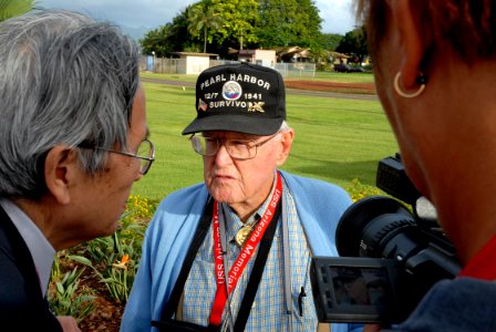 US Navy 061203-N-4774B-017 William Bob Johnson, Pearl Harbor Survivor, answer questions for Japanese news agency Asahi Broadcasting on Ford Island, at the location Johnson was the day of the 1941 attack on Pearl Harbor
